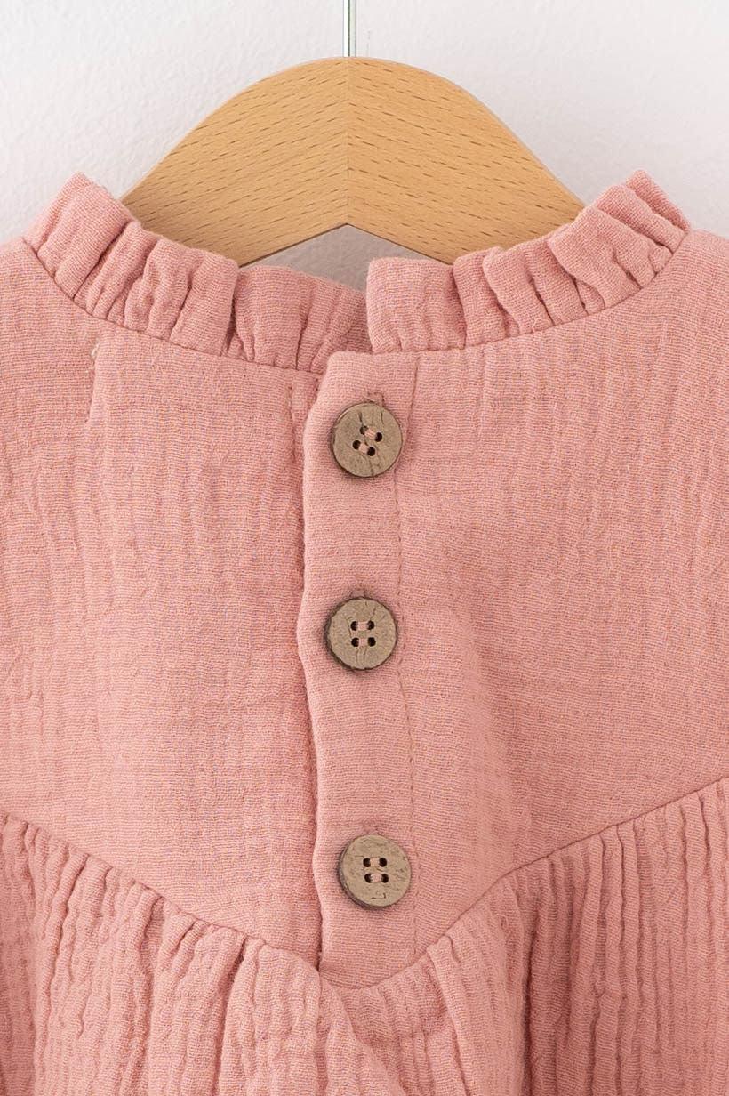Close-up of SOALSA pink baby dress with wooden buttons and ruffled collar Božična obleka za dojenčke
