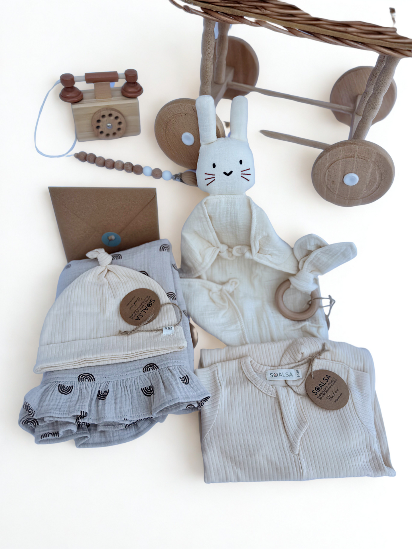 SOALSA Darilo za novorojenčka gift set with soft baby clothes, wooden toys, and a plush bunny