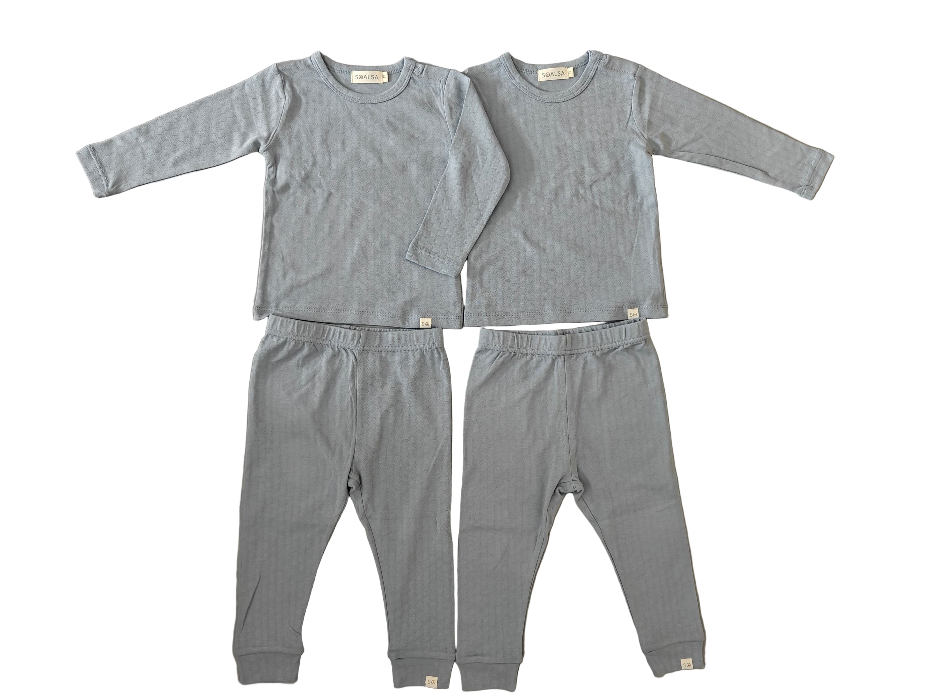 Gray children's pajama set on a tiled floor