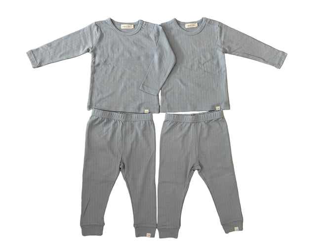 Gray children's pajama set on a tiled floor