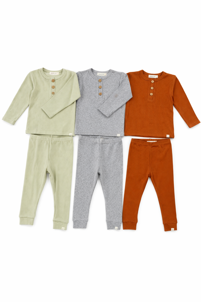Three sets of children's clothing in green, gray, and orange on a white background