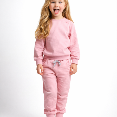 Young girl wearing a pink outfit on a white background