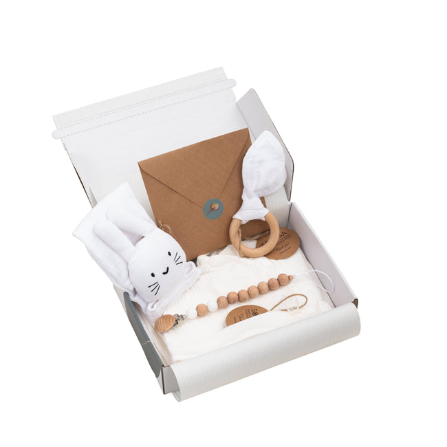 Baby gift set with toys and items in a box on a white background