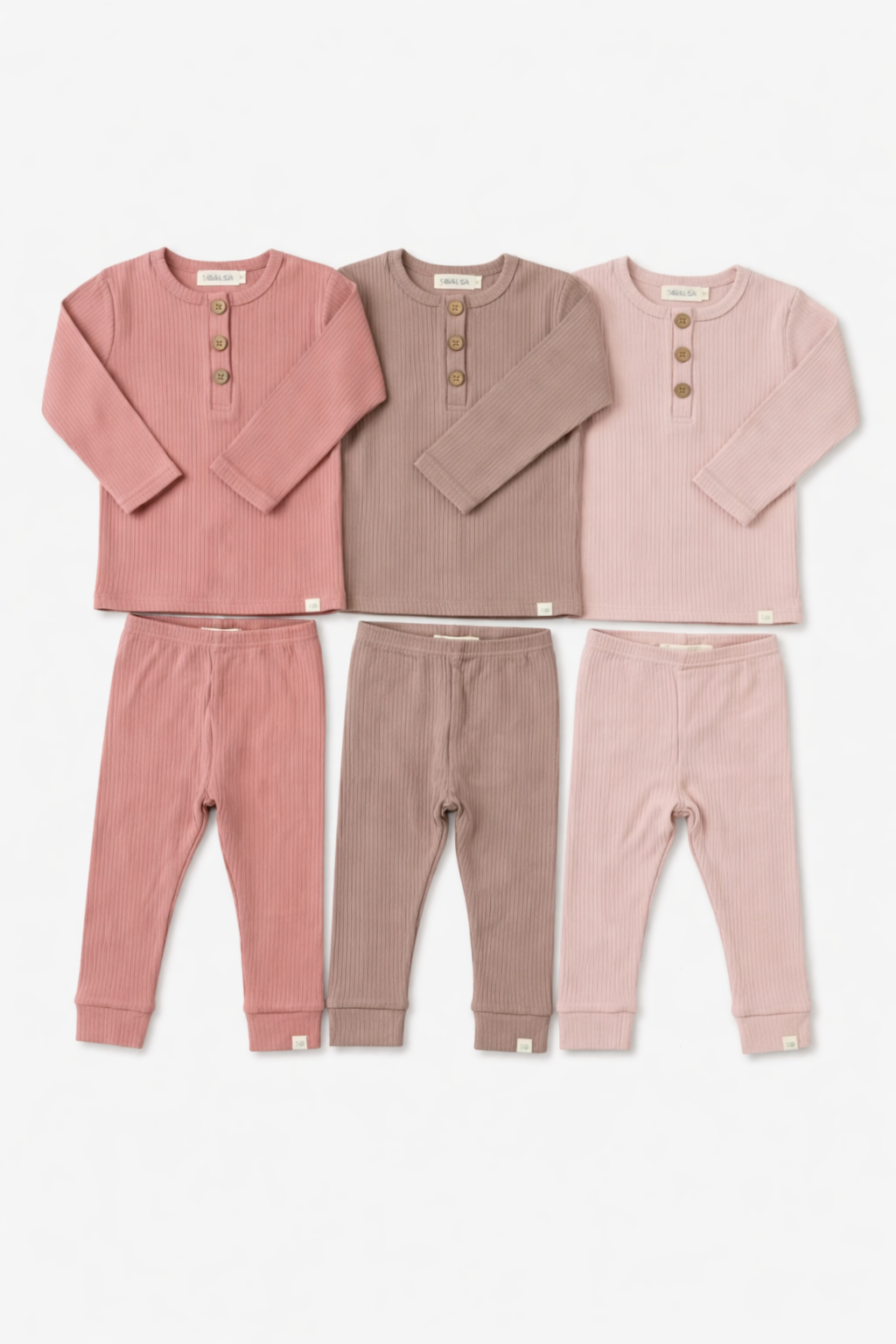 Set of three children's pajamas in pink and brown on a white background