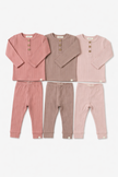 Set of three children's pajamas in pink and brown on a white background