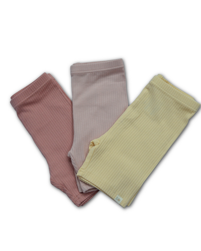 Three ribbed leg warmers in pink, beige, and green on a white background