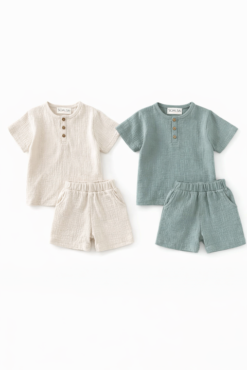 Two children's outfits, one beige and one green, on a white background.