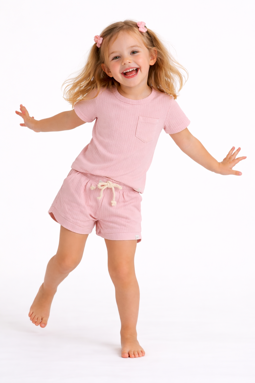 Child wearing a pink outfit on a white background