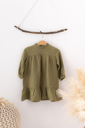 SOALSA muslin dress in olive green hanging on natural stick with Božične obleke za otroke keyword
