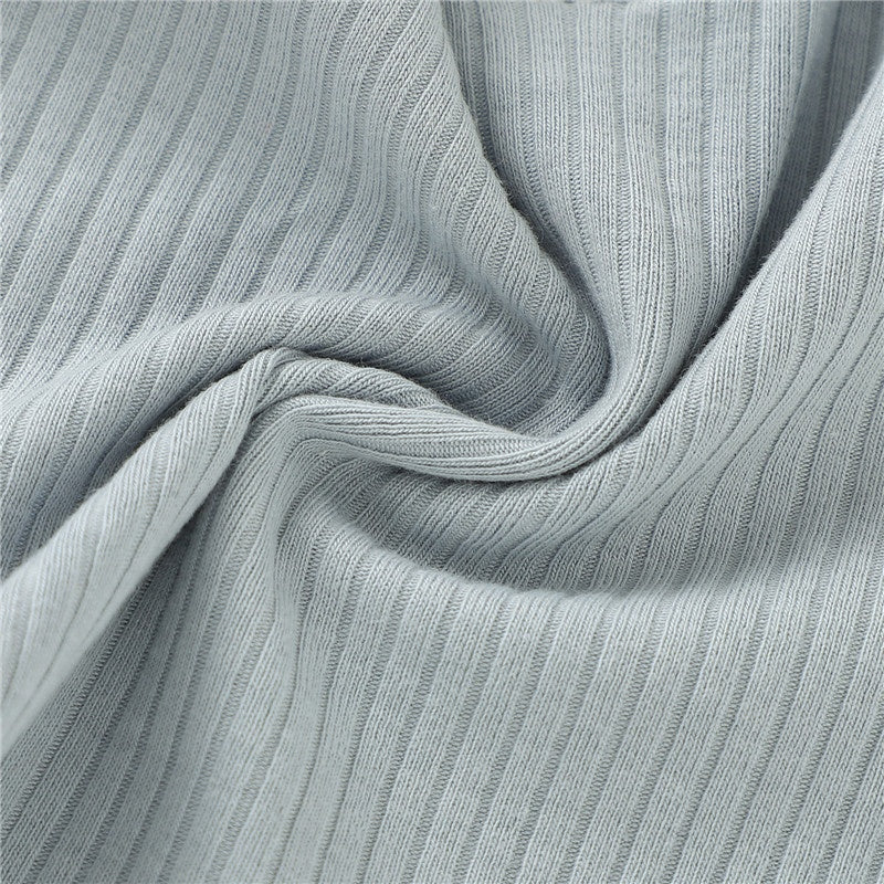 Close-up of ribbed fabric with a light gray color.