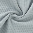 Close-up of ribbed fabric with a light gray color.