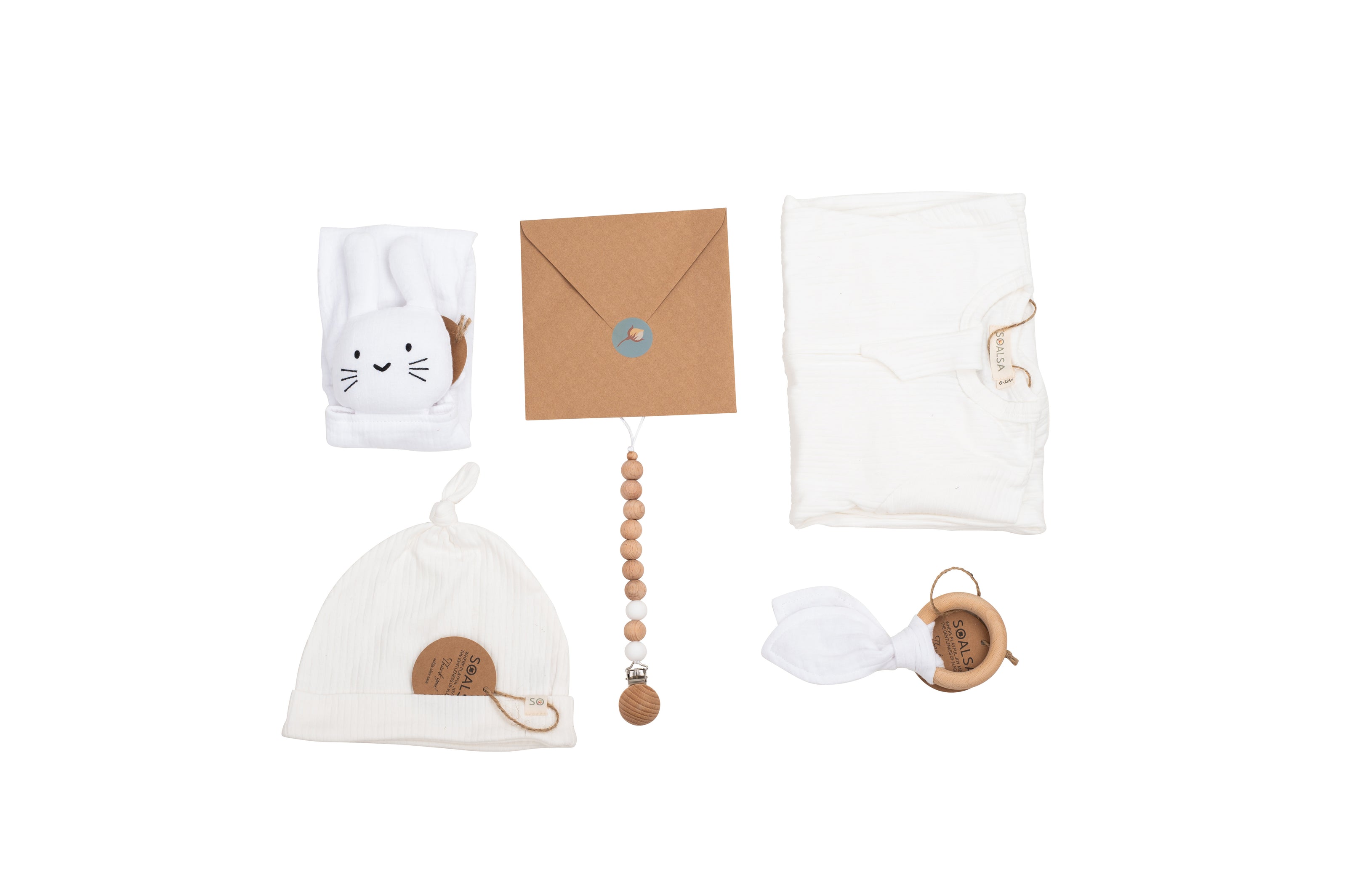 Collection of baby items including a hat, blanket, and toys on a white background