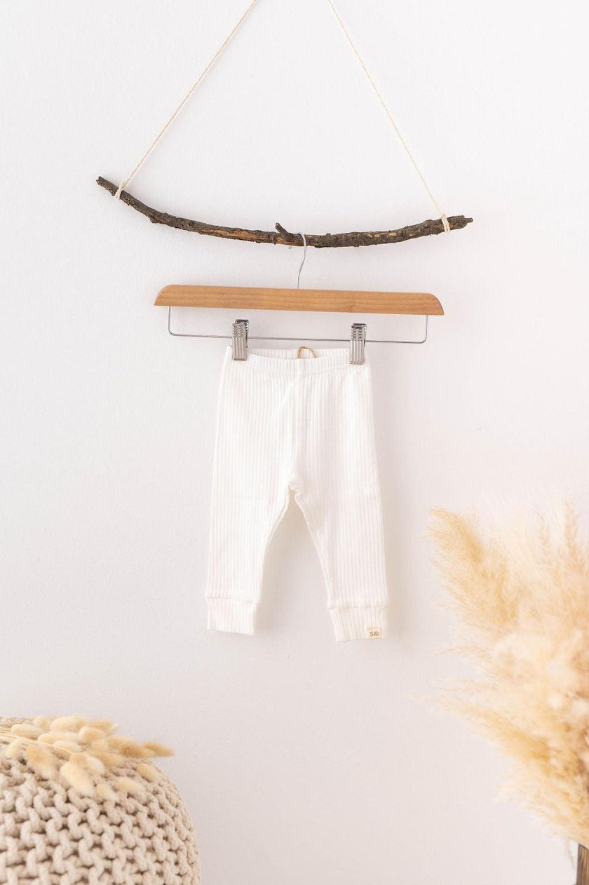 SOALSA bele bombažne otroške hlačke obešene na lesen obešalnik – komplet za novorojenčka.