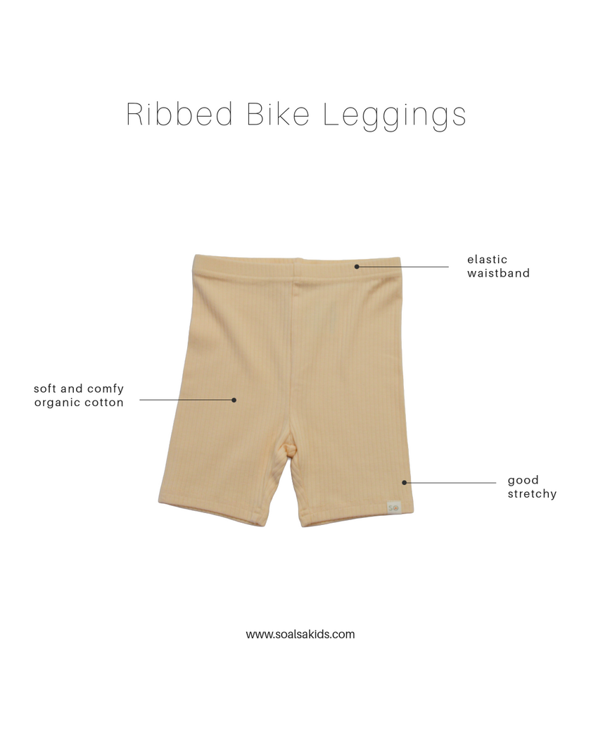Beige ribbed bike leggings with text labels on a white background