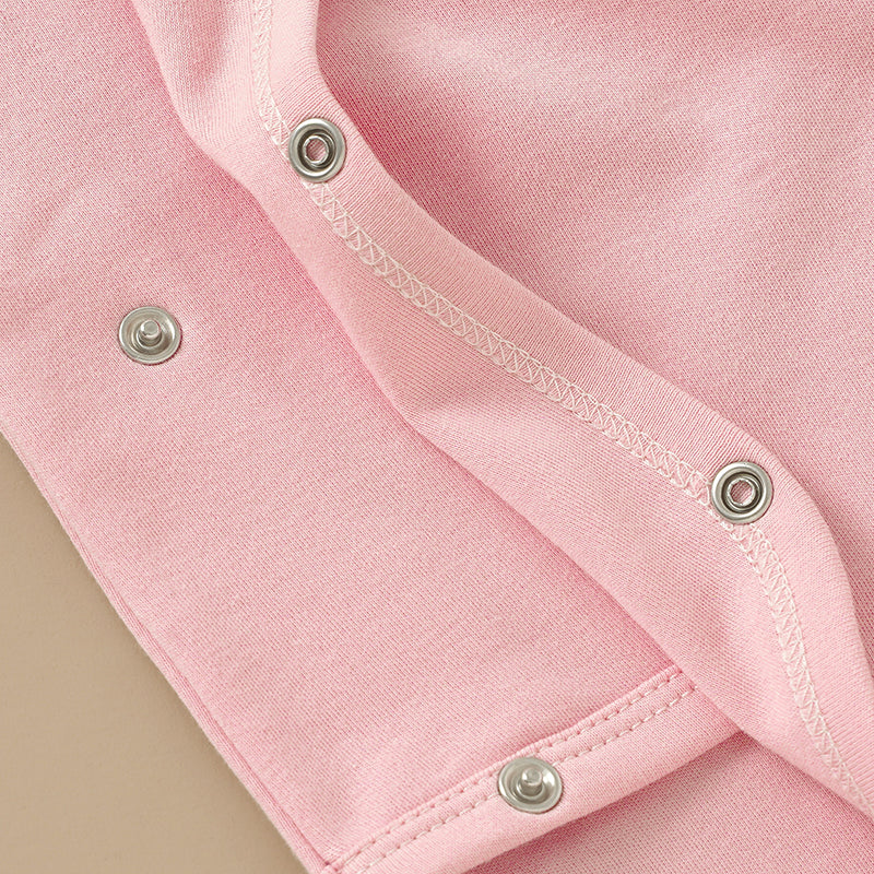 Close-up of pink Kimono Side-Snap Bodysuit by SOALSA featuring metal snaps for bodi na preklop design