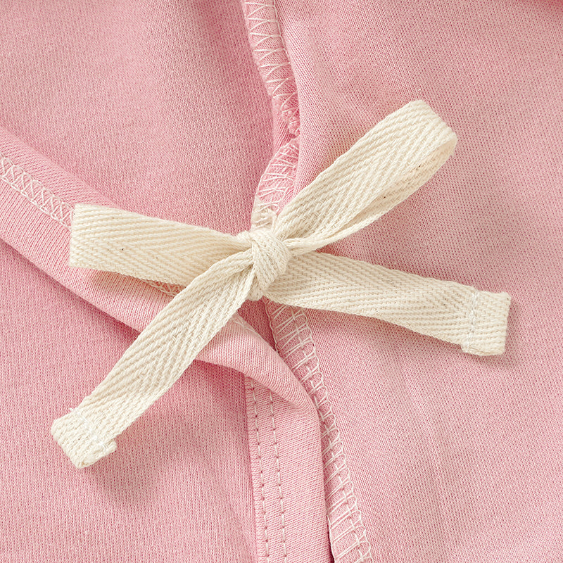 Close-up of SOALSA kimono side-snap bodysuit pink fabric with cream tie detail bodi na preklop